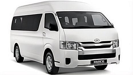 Toyota Hiace High Grade warna putih difoto dari sudut depan samping, menampilkan bodi van panjang dengan kapasitas besar, kaca jendela lebar di setiap baris kursi, dan desain grille depan yang tegas. Sebagai armada sewa mobil di Medan, Hiace menjadi pilihan utama untuk rombongan besar seperti study tour, rombongan wisata ke Danau Toba/Berastagi, antar-jemput bandara Kualanamu, hingga acara pernikahan dan perusahaan yang membutuhkan kapasitas hingga 15 penumpang
